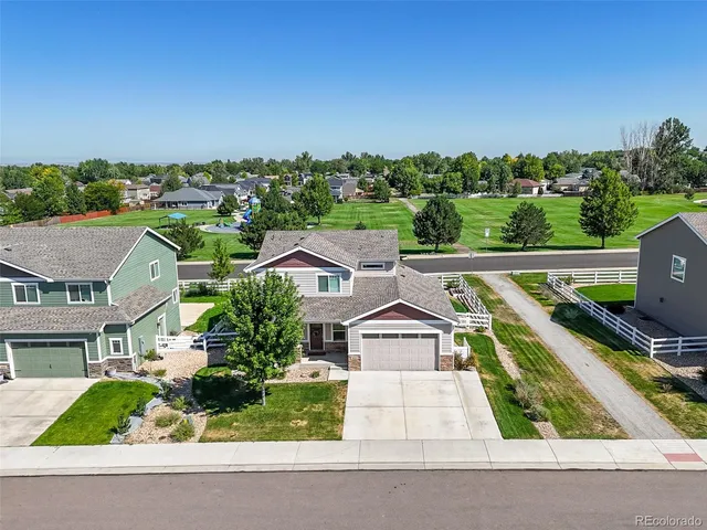 an aerial view of a house with a garden and trees