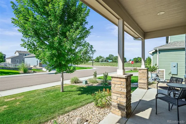 a view of backyard with seating area and green space