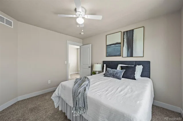 a bedroom with a large bed and a chandelier
