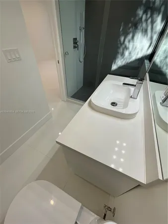 a bathroom with a sink and shower