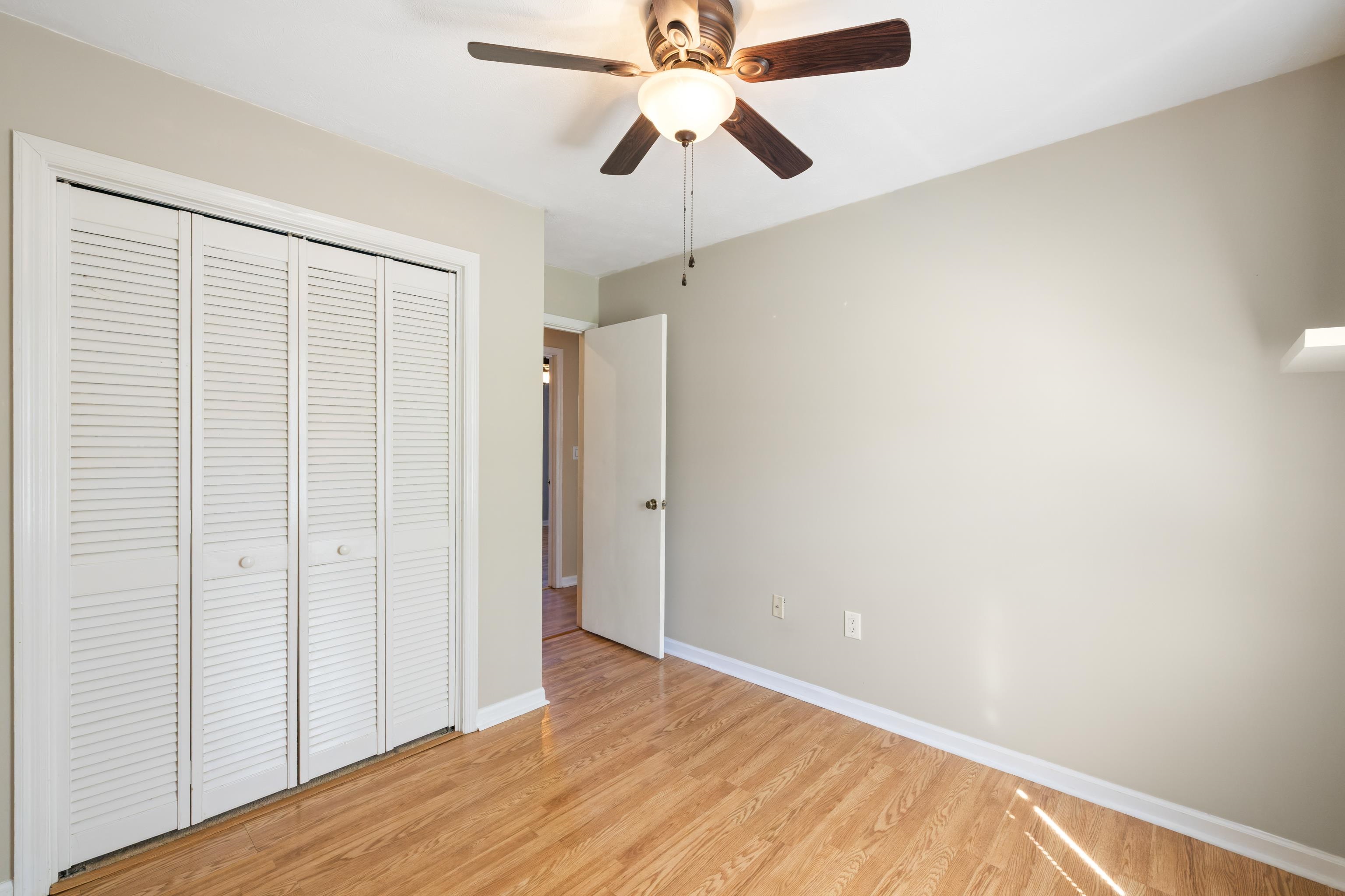 169 Mill Stone Drive Verona, VA 24482 - Photo 28 of 54 an empty room with a ceiling fan and wooden floor