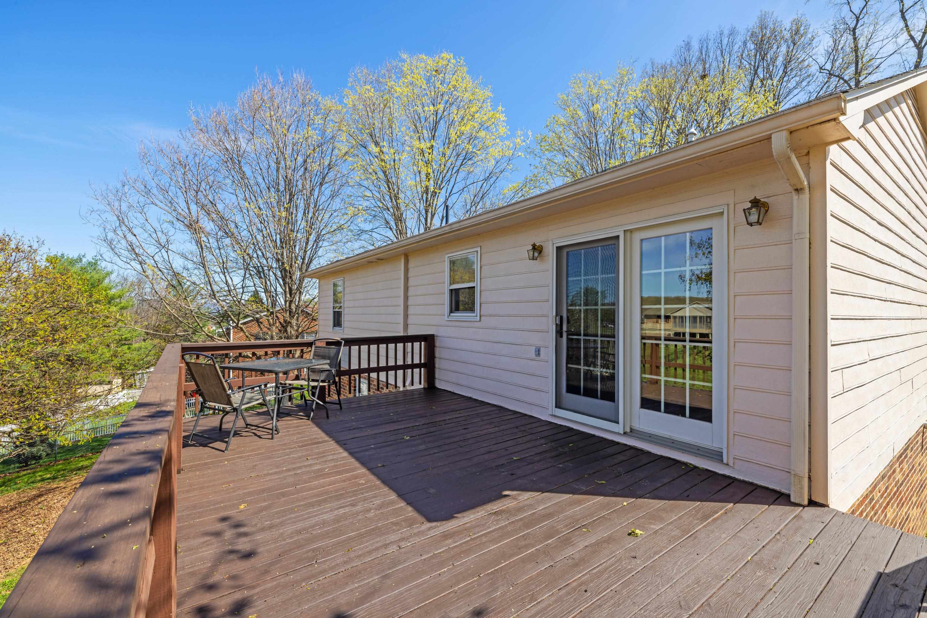 169 Mill Stone Drive Verona, VA 24482 - Photo 37 of 54 a view of a chair and table on the wooden deck