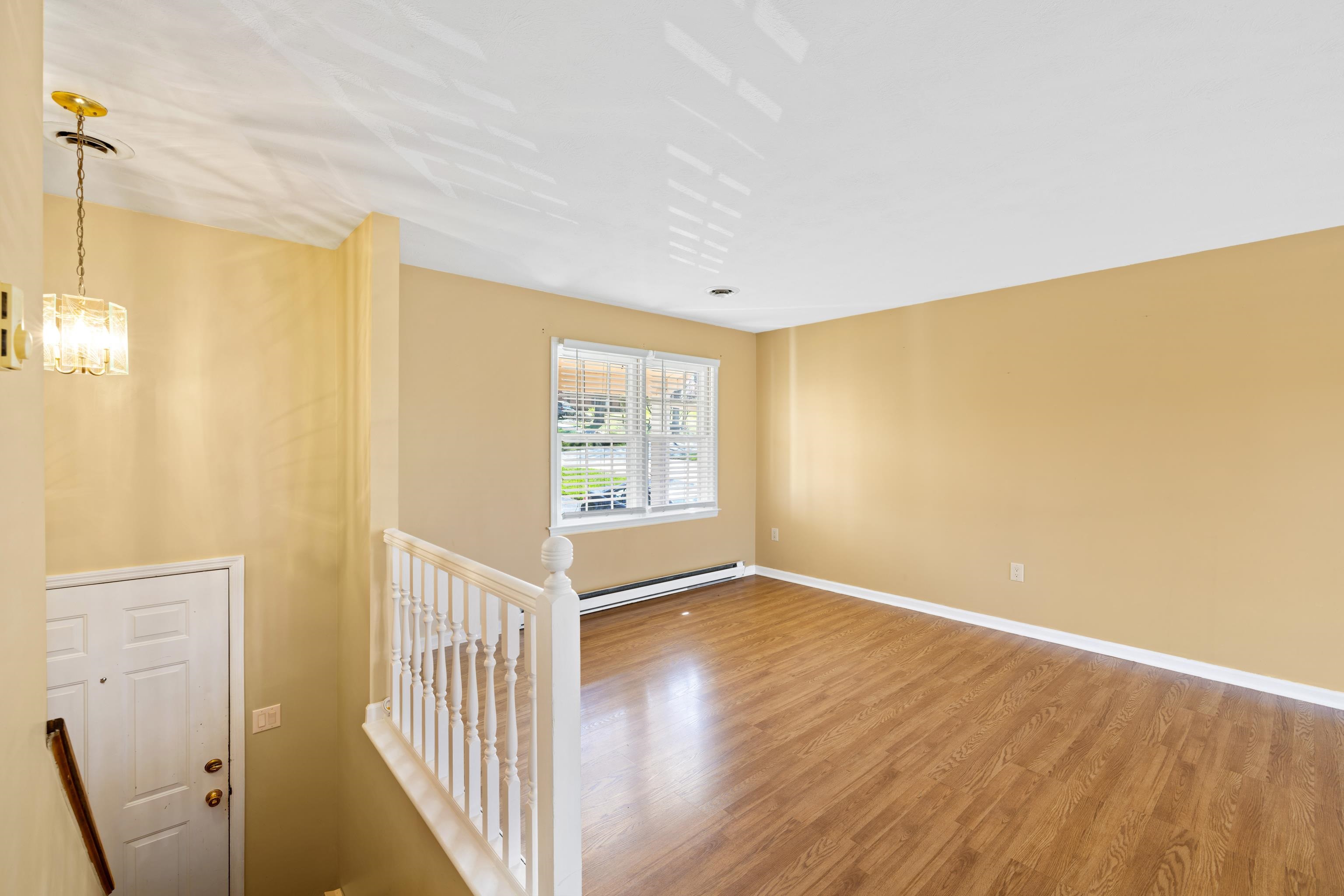 169 Mill Stone Drive Verona, VA 24482 - Photo 8 of 54 a view of an empty room with wooden floor and a window