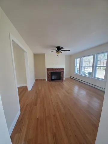 wooden floor in an empty room with a window