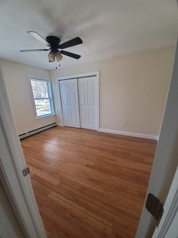 236-238 High Street, Unit 1 Reading, MA 01867 - Photo 6 of 7 an empty room with wooden floor fan and windows