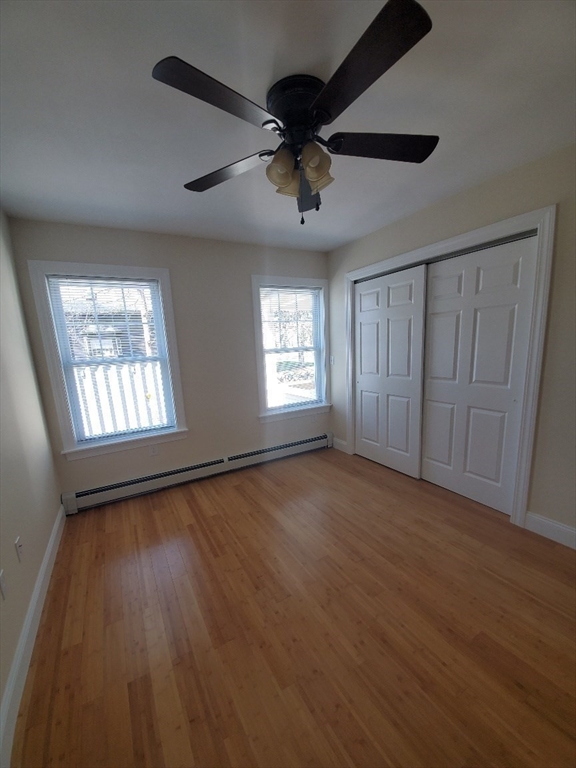 236-238 High Street, Unit 1 Reading, MA 01867 - Photo 7 of 7 a view of an empty room with a window and wooden floor