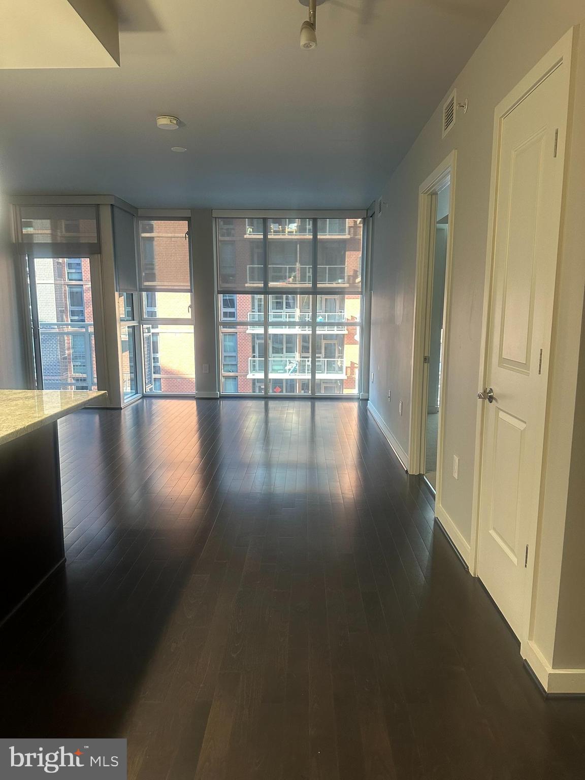 1025 First Street Southeast, Unit 901 Washington, DC 20003 - Photo 12 of 56 an empty room with wooden floor and windows