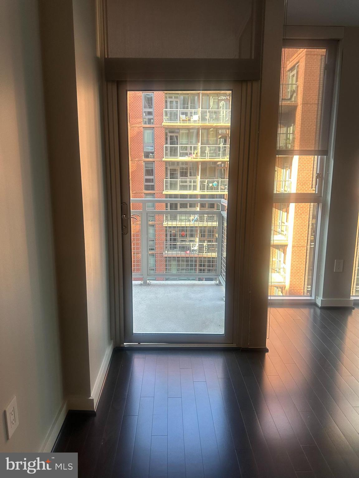 1025 First Street Southeast, Unit 901 Washington, DC 20003 - Photo 13 of 56 a view of an empty room with wooden floor and a window