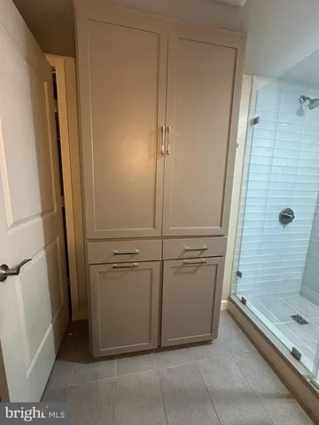 a spacious bathroom with a double vanity sink a mirror and a bathtub