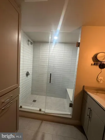 a bathroom with a granite countertop sink a toilet and mirror