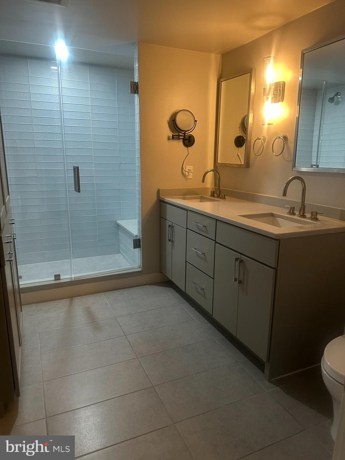 1025 First Street Southeast, Unit 901 Washington, DC 20003 - Photo 26 of 56 a bathroom with a granite countertop sink a toilet and mirror