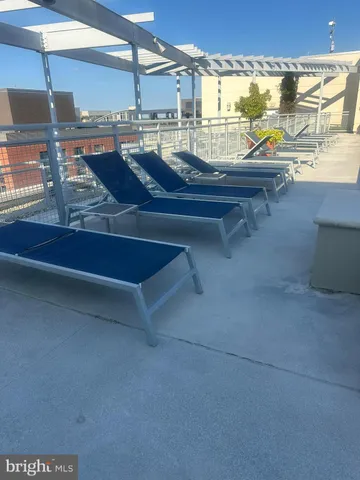 a view of a swimming pool and outdoor seating