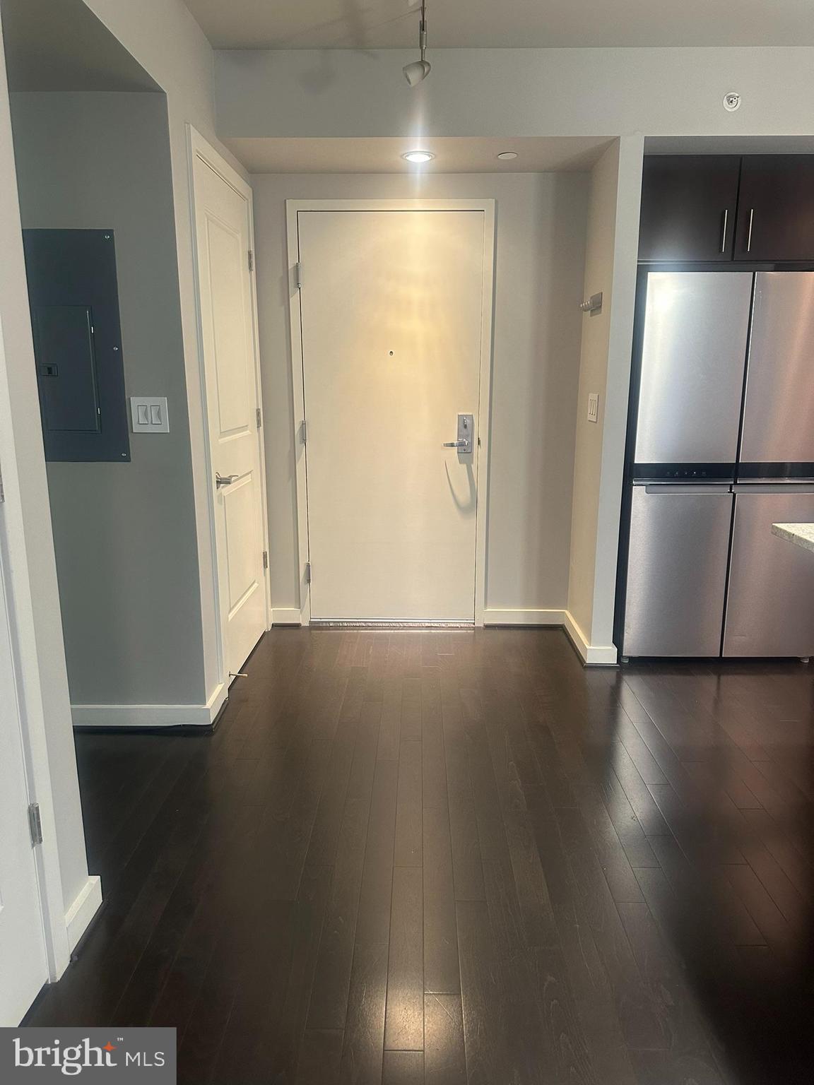 1025 First Street Southeast, Unit 901 Washington, DC 20003 - Photo 5 of 56 an empty room with wooden floor and cabinet
