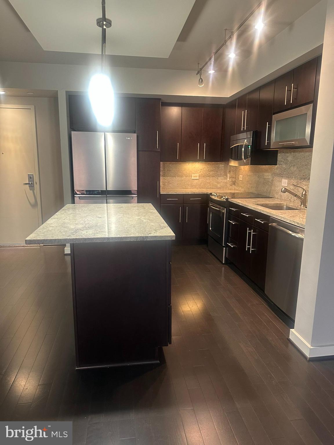 1025 First Street Southeast, Unit 901 Washington, DC 20003 - Photo 6 of 56 a kitchen with stainless steel appliances granite countertop a sink counter space and cabinets