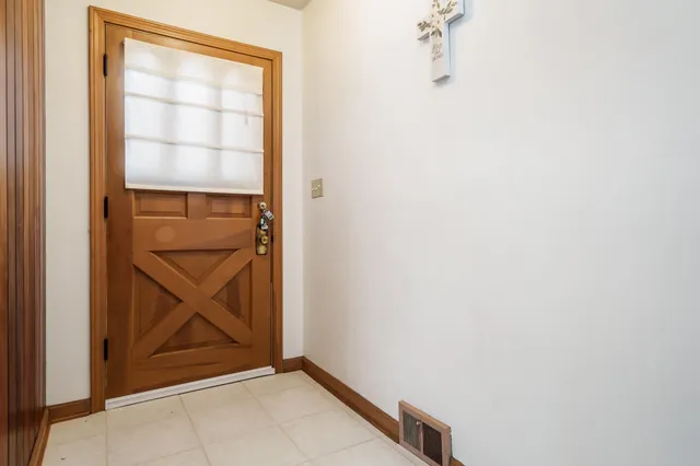 an empty room with a fireplace and cabinet