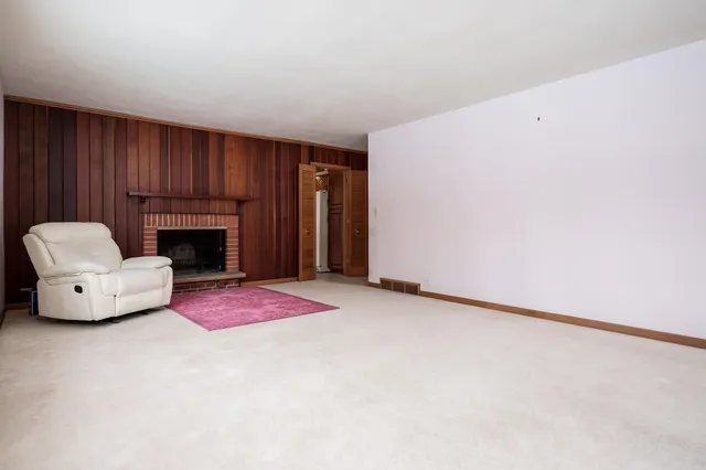 an empty room with furniture and a fireplace