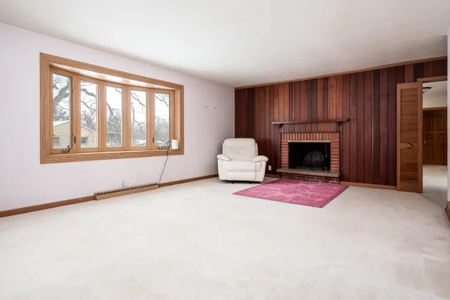 a living room with furniture a fireplace and a window