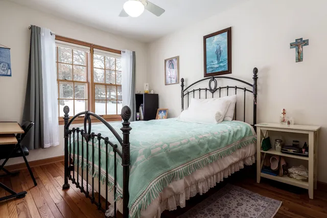 a bedroom with a bed and a chandelier