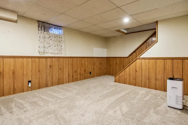 a view of an empty room with a cabinet and mirrors