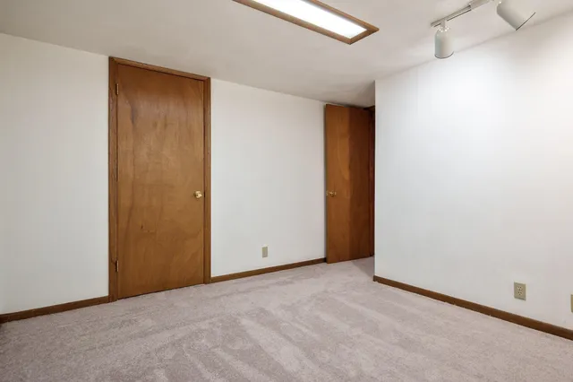 a bathroom with a toilet a sink a mirror and vanity
