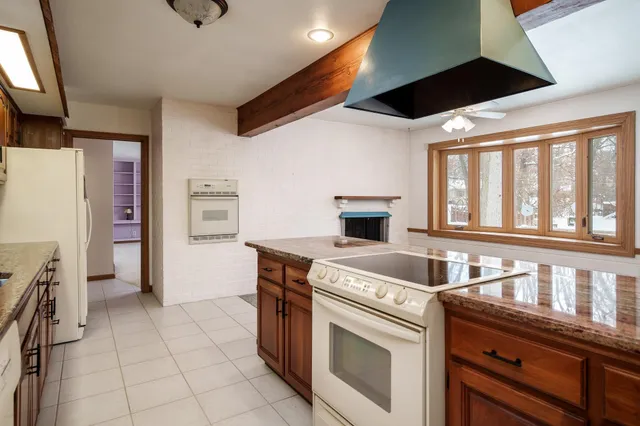 a kitchen with stainless steel appliances granite countertop a sink and a stove