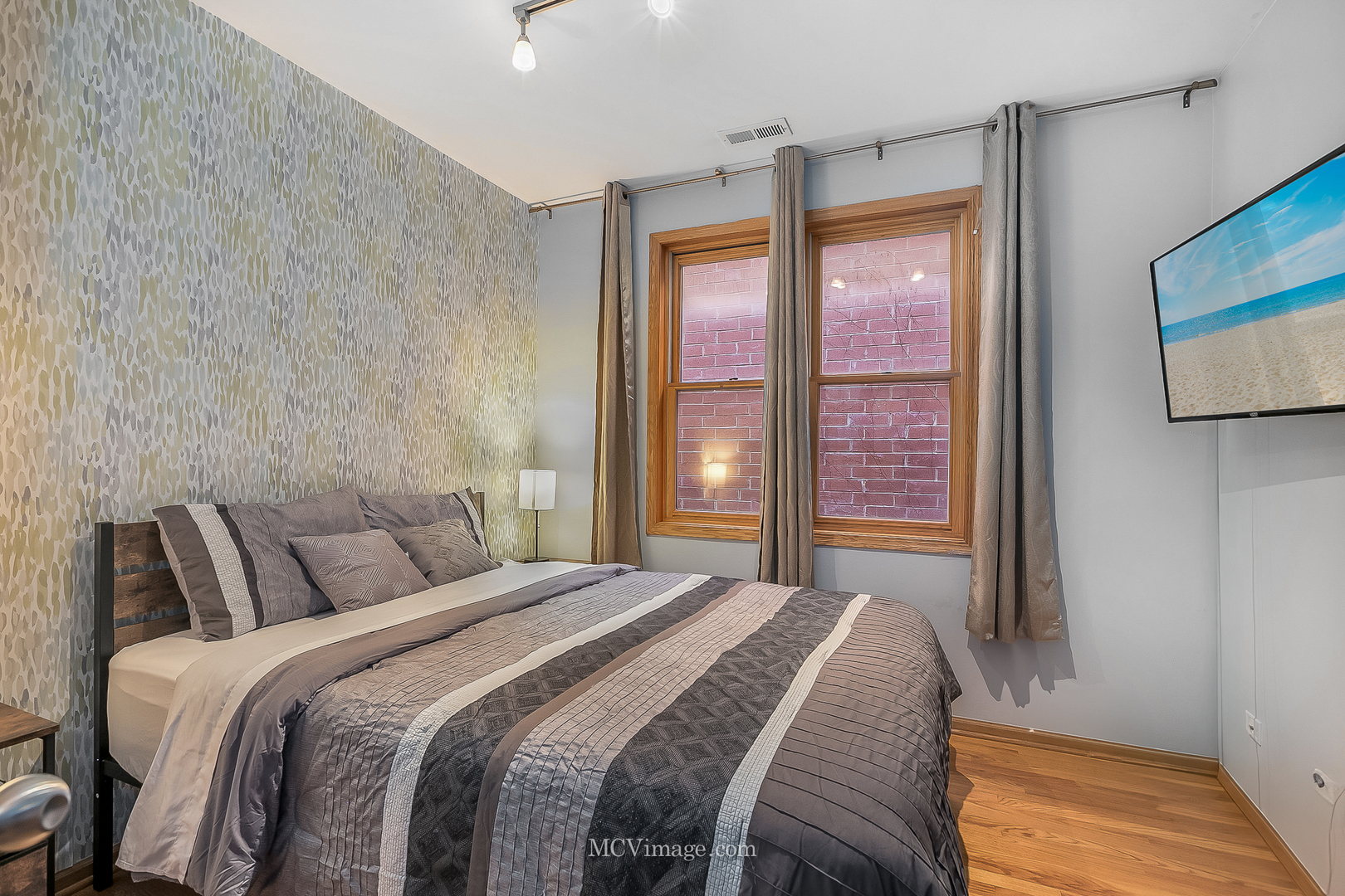 3751 South Michigan Avenue, Unit 2 Chicago, IL 60653 - Photo 5 of 12 a bedroom with a large bed and a large window