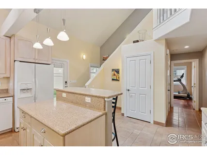 a kitchen that has a lot of cabinets and wooden floor