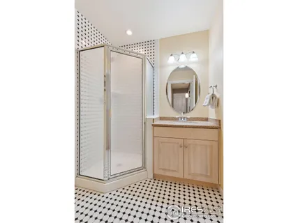 a bathroom with a sink a mirror and shower