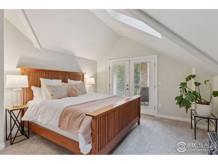 a bedroom with a bed table and a chair