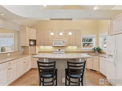a kitchen with stainless steel appliances a sink stove and white cabinets