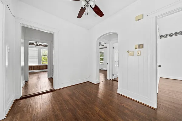 wooden floor in an empty room with a window