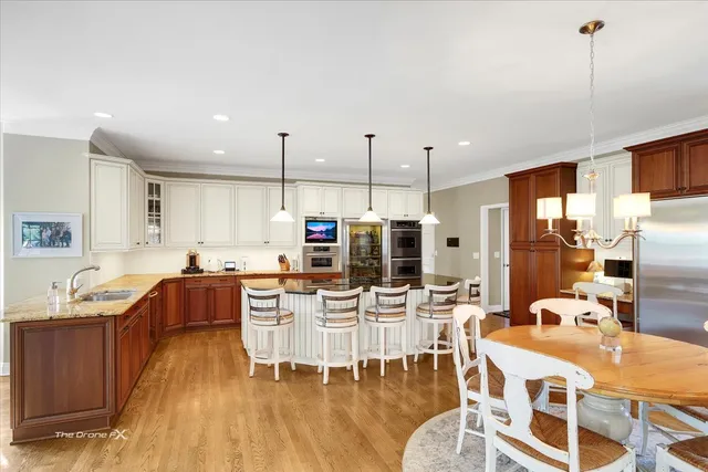 a living room with furniture large window and wooden floor