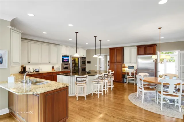 a large living room with stainless steel appliances kitchen island granite countertop furniture and a large window