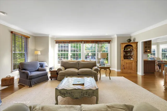 a view of a dining room with furniture a chandelier and wooden floor