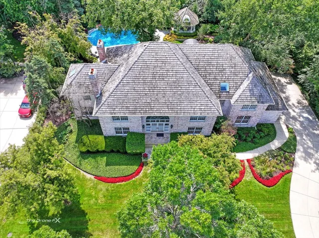 a front view of a house with a yard and outdoor seating