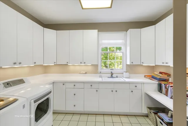 a bathroom with a granite countertop tub sink double vanity window and mirror