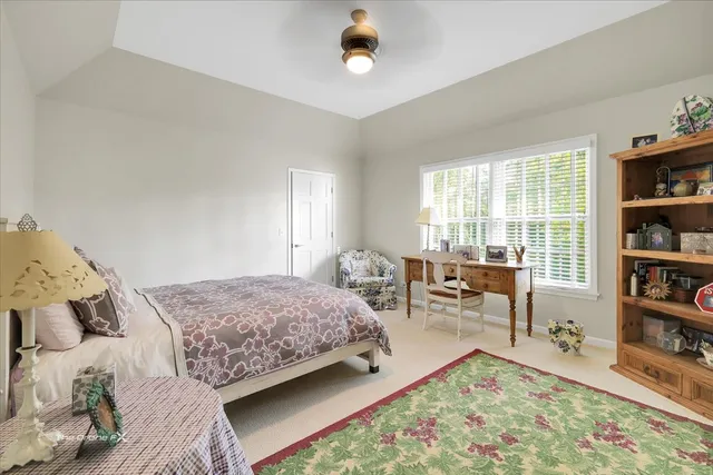 an aerial view of a house with a yard and lake view