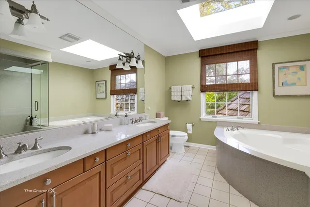 a front view of a house with a yard and tree