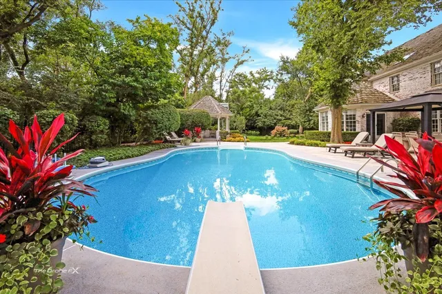 an aerial view of a residential houses with outdoor space and street view