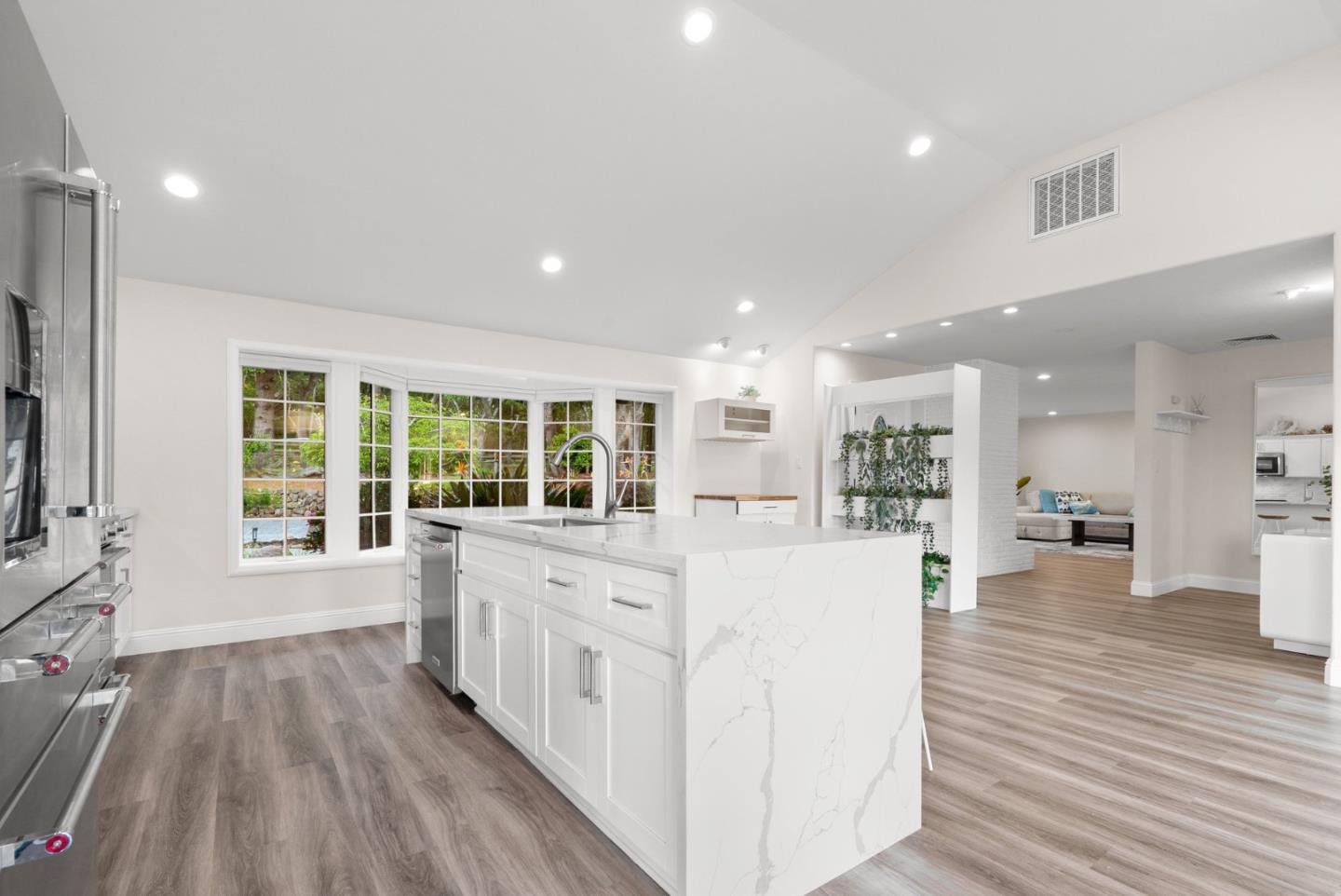 770 Graham Hill Road Santa Cruz, CA 95060 - Photo 24 of 83 a large white kitchen with wooden floors and wide window