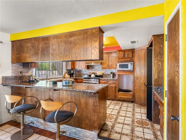 a kitchen with stainless steel appliances granite countertop a sink and cabinets