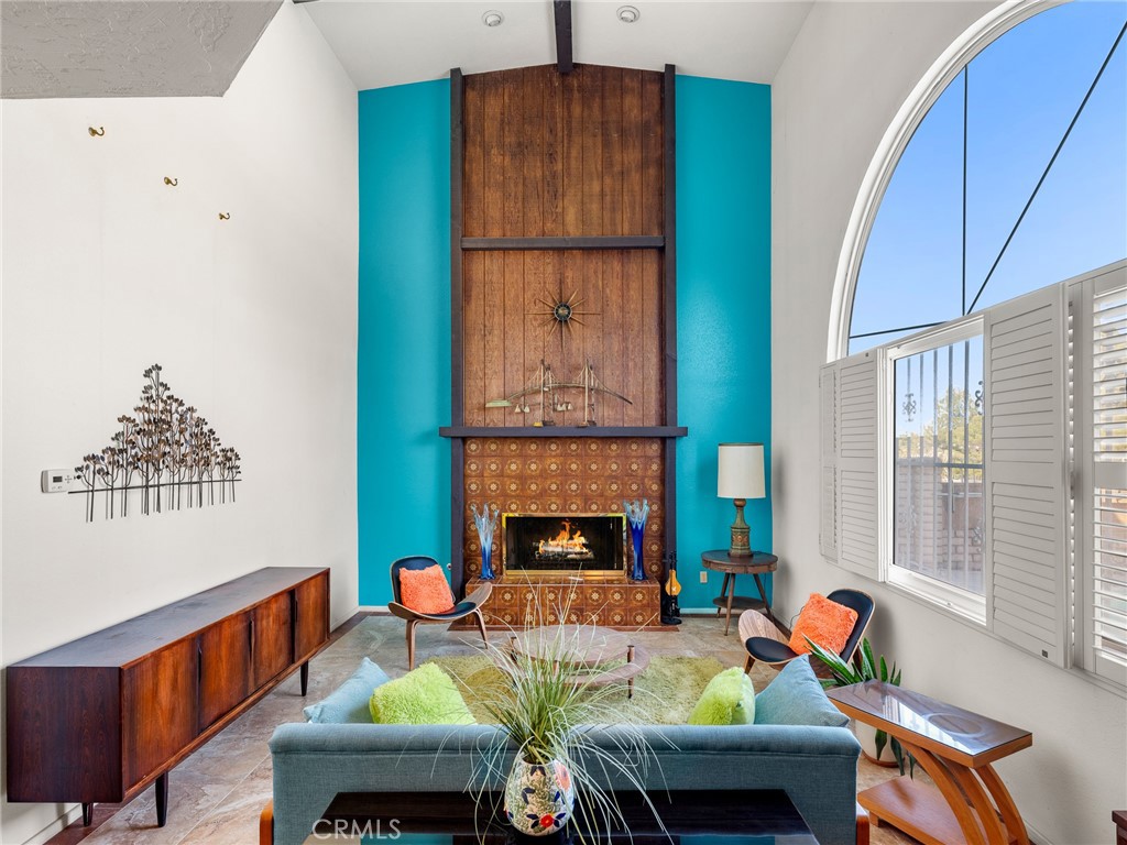 13916 Burning Tree Drive Victorville, CA 92395 - Photo 28 of 49 a living room with furniture a fireplace and a window