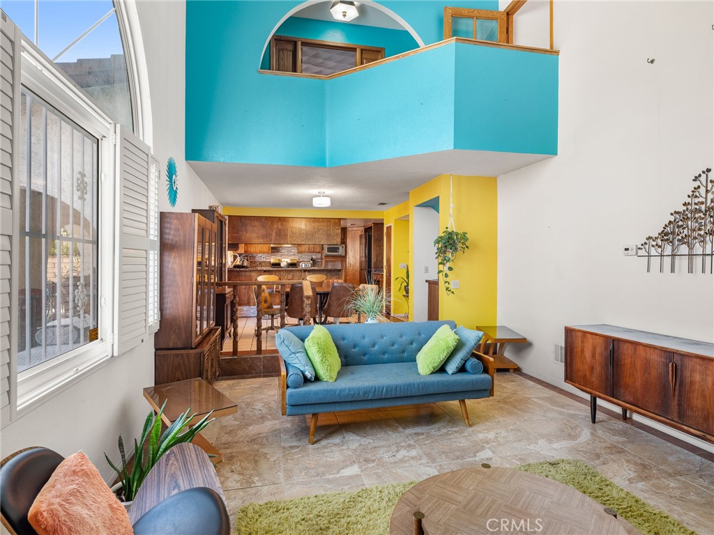 13916 Burning Tree Drive Victorville, CA 92395 - Photo 29 of 49 a living room with patio furniture and a potted plant