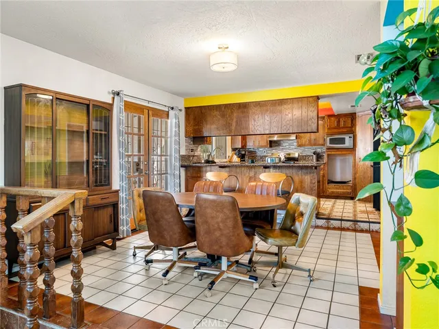 a dining room with furniture and a floor to ceiling window