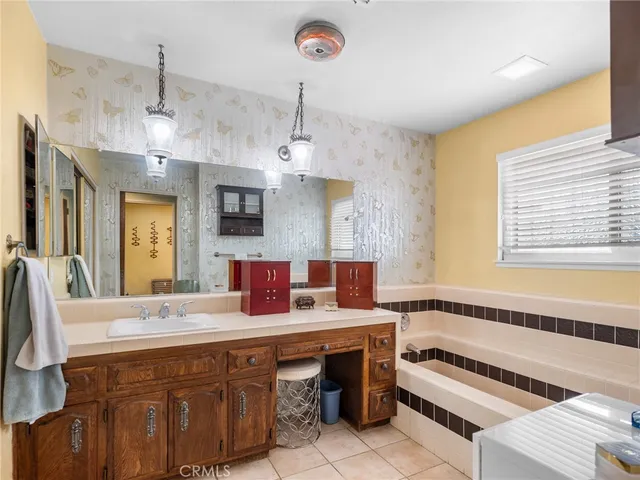 a bathroom with a double vanity sink and a bathtub