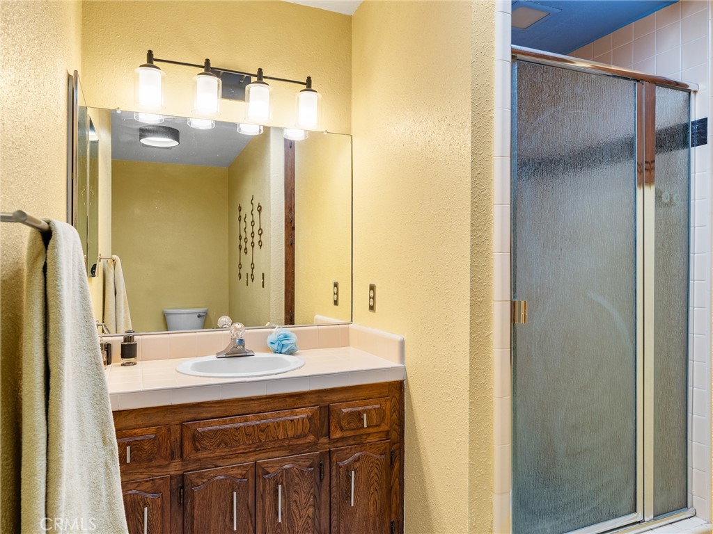 13916 Burning Tree Drive Victorville, CA 92395 - Photo 37 of 49 a bathroom with a sink and a mirror