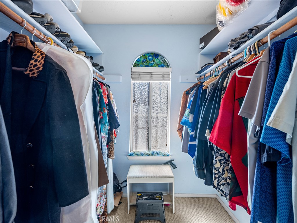 13916 Burning Tree Drive Victorville, CA 92395 - Photo 38 of 49 a view of walk in closet with clothes and shoes