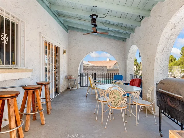 a view of a patio with plants and chairs potted plants