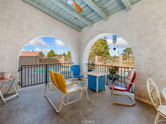 a view of a terrace with furniture and a garden