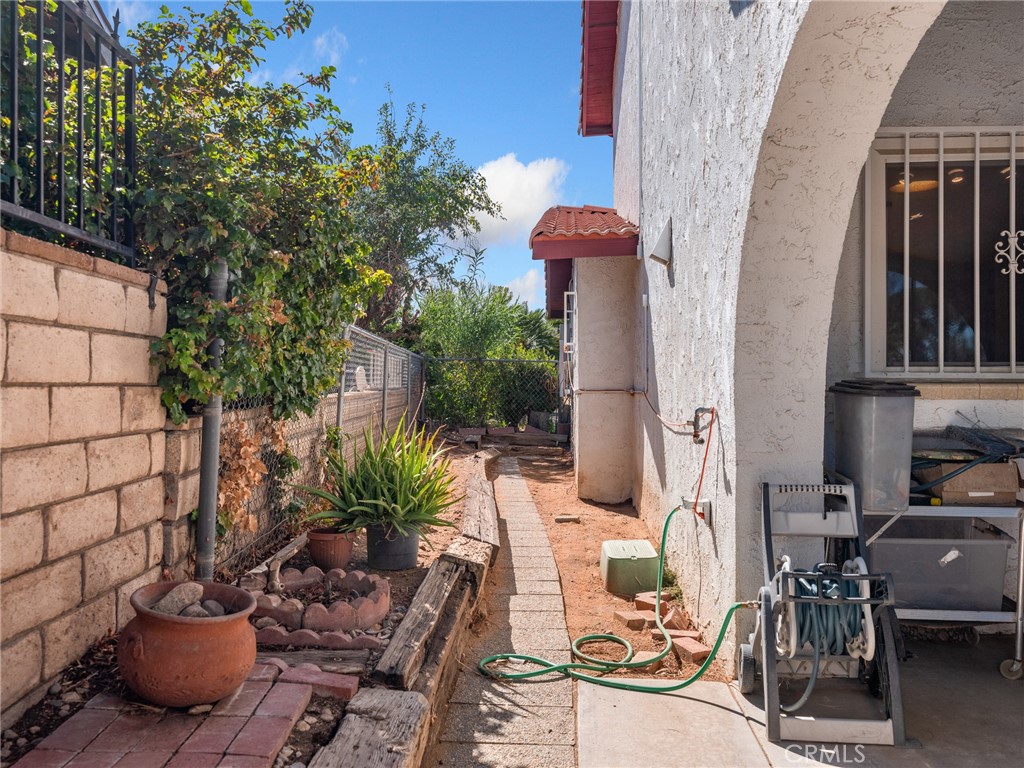 13916 Burning Tree Drive Victorville, CA 92395 - Photo 42 of 49 a view of a patio with plants and chairs potted plants
